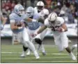  ?? MARK LAMBIE — THE ASSOCIATED PRESS ?? North Carolina quarterbac­k Mitch Trubisky tries to ward off Stanford linebacker Mike Tyler during the second half of the Sun Bowl NCAA college football game.