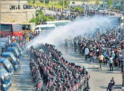  ?? AFP ?? Police use water cannon against protesters in Naypyidaw.