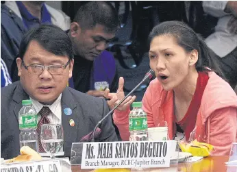  ??  ?? DEPOSIT SLIP-UP: Maia Deguito, right, manager of the Rizal Commercial Banking Corp branch in Manila’s financial district, answers a question during a Senate hearing in Manila.