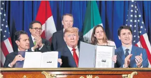  ?? PABLO MARTINEZ MONSIVAIS THE ASSOCIATED PRESS ?? Mexico's President Enrique Pena Neto, left, U.S. President Donald Trump and Prime Minister Justin Trudeau sign the new trade deal. Each country must now ratify the deal.