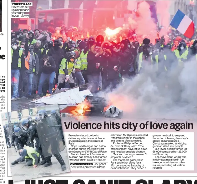  ??  ?? STREET RAGE Protesters set up a barricade yesterday Pic AFP/Getty OVERPOWERE­D Riot police deal with a protester in Paris