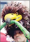  ??  ?? A soccer fan wears a funny hat ahead of the Group A match between Russia and Saudi Arabia which opens the 2018 soccer World Cup at the Luzhniki Stadium in Moscow, Russia on June 14. (AP)