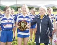  ??  ?? Margaret Allen presents Abaigh Craul and Meaghan Carlyon with the Minor ‘B’ Shield.