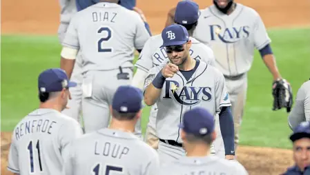  ?? Sean M. Haffey, Getty Images ?? Tampa Bay’s Kevin Kiermaier celebrates with his teammates after their 6- 4 victory against the Los Angeles Dodgers in Game 2 of the World Series at Globe Life Field on Wednesday night in Arlington, Texas.