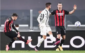  ?? — AFP photo ?? AC Milan’s midfielder Brahim Diaz (left) shoots to open the scoring during the Italian Serie A match against Juventus at the Juventus stadium in Turin.