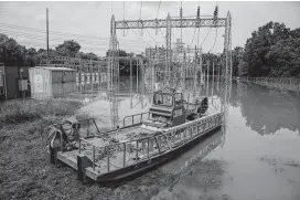  ?? Michael Ciaglo / Staff file photo ?? A CenterPoin­t Energy boat sits at a flooded substation Sept. 3, 2017, in Houston. Hurricane Harvey dumped more than 50 inches of rain on the area. Residents launched their own boats to rescue others trapped in their homes, often at great personal risk.