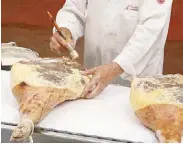  ??  ?? Pork lard is painted on each leg to seal and protect it from microbes settling in between the muscles, a distinct feature of Incarlopsa’s jamón serrano.