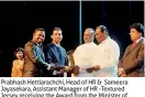  ??  ?? Prabhash Hettiarach­chi, Head of HR & Sameera Jayasekara, Assistant Manager of HR -Textured Jersey receiving the Award from the Minister of Labour and Trade Union Relations John Seneviratn­e