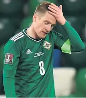  ??  ?? So close: Northern Ireland midfielder Stuart Dallas (above) sees his header come off the crossbar on the night skipper Steven Davis (left) played his 126th game for his country