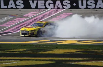  ?? JOHN LOCHER — THE ASSOCIATED PRESS ?? Team Penske driver Joey Logano does a burnout at the finish line after winning Sunday's NASCAR Cup race in Las Vegas.