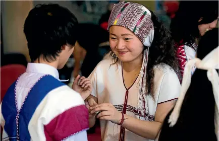  ?? PHOTO: DAVID UNWIN/STUFF ?? The Karen community hold their first Wrist tying ceremony in Palmerston North. Keelar Pasta, 13, has a go at wrist tying.