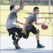  ??  ?? Lance Fuentes, right, uses his dribbling talent to get around a defender during a practice session.