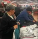  ?? PEG DEGRASSA — DIGITAL FIRST MEDIA ?? Linda Starke, left, and Beverly Hughes, right, both residents of Philadelph­ia, shopped for Eagles NFC Championsh­ip merchandis­e at Modell’s in Clifton Heights on Monday.