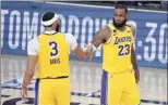  ?? AP photo ?? The Lakers’ Anthony Davis and LeBron James shake hands in the final moments of Thursday’s game.