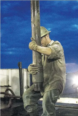  ?? ANDREW BURTON/GETTY IMAGES FILES ?? A worker drills for oil in the Bakken shale formation outside Watford City, North Dakota. The U.S. Federal Reserve may be the strongest tailwind for oil prices if it continues on its tightening path, which could lead to a cap on U.S. supply and support...