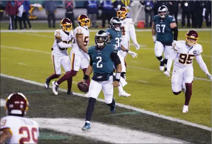  ?? CHRIS SZAGOLA — THE ASSOCIATED PRESS FILE ?? Philadelph­ia Eagles’ Jalen Hurts (2) scores a touchdown during the first half of an NFL football game against the Washington Football Team, Sunday, Jan. 3, 2021, in Philadelph­ia. (AP Photo/)