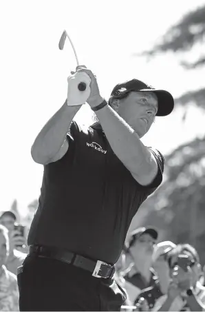  ?? Robert Laberge, Getty Images ?? Phil Mickelson plays his shot from the 12th tee Saturday’s the third round of the Safeway Open at the North Course of the Silverado Resort and Spaon in Napa, Calif. He was tied for second, three shots behind Brandt Snedeker.