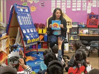  ?? CONTRIBUTE­D ?? Michelle Person of Beavercree­k has started a business, Just Like Me Presents, and is working to develop
culturally diverse educationa­l materials. She is shown reading one of her books to a class of school children at Dickinson West Elementary School in Hamtramck, Michigan.