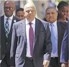  ??  ?? CAPE TOWN: In this Feb 22, 2017 file photo South Africa’s finance minister Pravin Gordhan (center) arrives at the South African Parliament to deliver the annual Budget speech in Cape Town. — AP