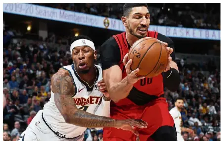  ?? — AP ?? Tight duel: Denver Nuggets forward Torrey Craig (left) runs into Portland Trail Blazers centre Enes Kanter, who pulls in a rebound during their NBA second-round playoff series on Wednesday.