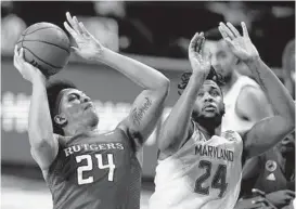  ?? CORTEZ/AP
JULIO ?? Maryland’s Donta Scott defends Rutgers guard Ron Harper Jr. during the Terps’ loss to the Scarlet Knights. Maryland is hoping to improve its defensive effort as the season goes on.