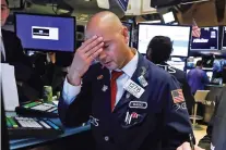  ?? RICHARD DREW/ASSOCIATED PRESS ?? Specialist Mario Picone works Wednesday on the floor of the New York Stock Exchange. The Dow Jones Industrial Average sank 800 points after the bond market flashed a warning sign about a possible recession.