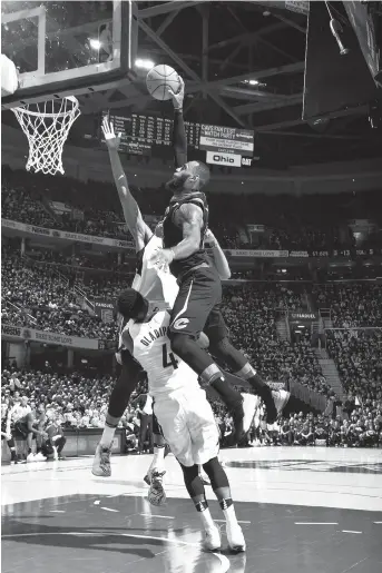  ??  ?? LeBron James (left) of the Cleveland Cavaliers goes to the basket past Victor Oladipo of the Indiana Pacers in Game 1 of their first-round Eastern Conference series in the NBA Playoffs at Quicken Loans Arena in Cleveland on Sunday. — AFP