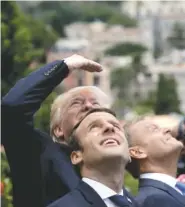  ?? THE ASSOCIATED PRESS ?? U.S. President Donald Trump, left, French President Emmanuel Macron and EU Council President Donald Tusk, right, watch the Frecce Tricolori Italian Air Force acrobatic squadron performing, in Taormina, Italy, on Friday.