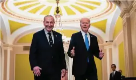  ?? Drew Angerer/Getty Images ?? Senate Majority Leader Chuck Schumer walks with President Joe Biden as he arrives at the Capitol on Thursday.