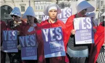  ??  ?? Supporters of a “yes” vote made their views known in Dublin by dressing as characters from the TV show The Handmaid’s Tale.