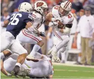  ?? MIKE DE SISTI / MILWAUKEE JOURNAL SENTINEL ?? UW’s Ryan Connelly (right) recovers a fumble and runs it in for a touchdown against Penn State in the Big Ten title game.