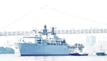  ??  ?? HMS Albion, the British Royal Navy flagship amphibious assault ship, arrives at Harumi Pier in Tokyo, Japan. — Reuters photo