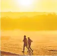  ?? ?? Joggers enjoy a colourful sunrise at Richmond Park in London yesterday