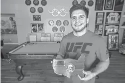  ?? SEAN LOGAN/AZCENTRAL SPORTS ?? Olympic wrestling gold medalist Henry Cejudo poses for a portrait on Wednesday at his home in Phoenix. Cejudo is being inducted into the Wrestling Hall of Fame.