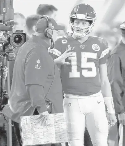  ?? KEVIN C. COX/GETTY ?? Chiefs head coach Andy Reid talks to quarterbac­k Patrick Mahomes during the fourth quarter in Super Bowl LIV against the 49ers at Hard Rock Stadium on Sunday in Miami.