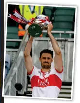  ??  ?? GLORY: Derry’s Ethan Doherty holds off David Dempsey of Offaly, (above) Chrissy McKaigue lifts the cup