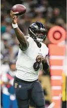  ?? GERALD HERBERT/AP ?? Ravens quarterbac­k Lamar Jackson throws a pass during the first half Monday night.