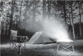  ??  ?? A campfire helps keep the site warm during a chilly night at Spirit of the Suwannee Music Park and Campground.