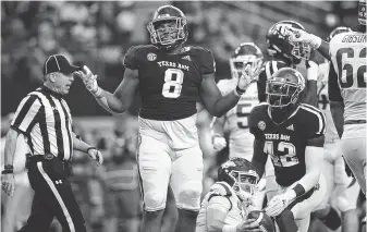  ?? Ronald Martinez / Getty Images ?? Texas A&amp;M’s Kingsley Keke (8) reacts after sacking Arkansas quarterbac­k Ty Storey in a Sept. 29 game. Keke leads the Aggies in sacks with 4½ and in tackles for loss with seven.