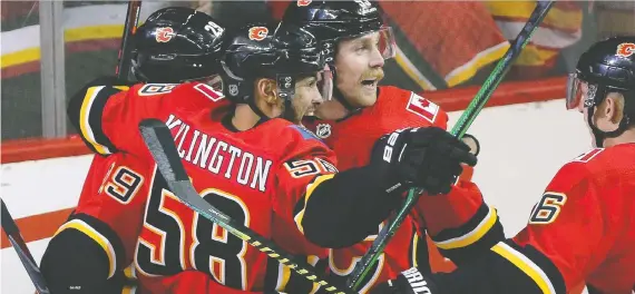  ?? GAVIN YOUNG ?? Teammates celebrate Sam Bennett’s first goal on Chicago Blackhawks goalie Robin Lehner in Calgary on Saturday, a game the Flames lost 8-4.