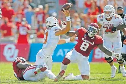  ??  ?? OU's David Ugwoegbu (2) tries to bring down Texas quarterbac­k Sam Ehlinger (11) beside Perrion Winfrey (8) during the Red River Showdown. OU won 53-45 in four overtimes. [BRYAN TERRY/ THE OKLAHOMAN]