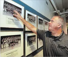  ??  ?? New Petes coach Rob Stewart points to his 1988-99 team photo at the Memorial Centre. The Petes alumnus, who has coached in Europe for 15 years, was recently named the 23rd coach in franchise history.