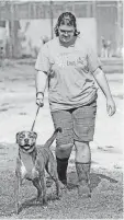  ??  ?? Susannah Devine walks Tiger at Free to Live animal sanctuary in Edmond. Free to Live is the largest no-kill sanctuary in Oklahoma.