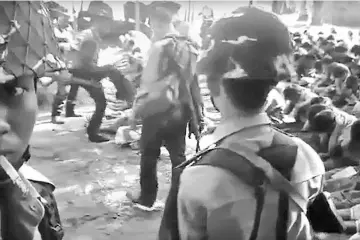  ??  ?? A file screen grab from a YouTube video originally taken by Myanmar constable Zaw Myo Htike (left, looking at camera) shows a policeman (back left) kicking out at a Rohingya minority villager seated on the ground with others, in the village of Kotankauk during a police area clearance operation on Nov 5, 2016. Three police officers have been sentenced to two months detention over the video showing them abusing Rohingya civilians, security sources told AFP. — AFP photo