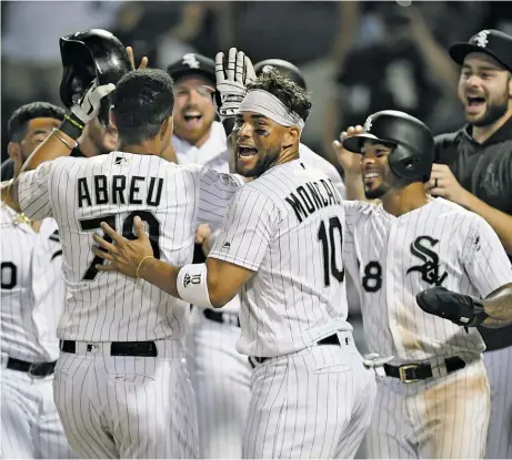  ?? GETTY IMAGES ?? Jose Abreu celebrates with teammates after hitting a walk-off home run in Game 2 of a doublehead­er sweep Wednesday against the Tigers.