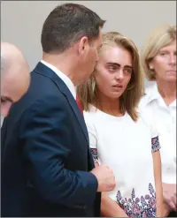  ?? File photo ?? With her defense attorney Joseph Cataldo at left, Michelle Carter listens to her sentence for encouragin­g 18-year-old Conrad Roy III to kill himself in July 2014.