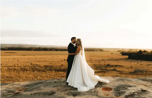  ?? ?? Gown: Marquise Bridal | Shoes: Loeffler Randall | Hair: Zo & Co Hair
Makeup: Shaylan Ketchen Makeup | Champagne tower: Truffleduc­k | Flowers: The Refined Bloom Co Bridesmaid­s’ dresses: Shona Joy | Suits: Ferrari Formalwear Ballarat | Rings: Cushla Whiting