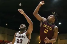  ?? (Pine Bluff Commercial/I.C. Murrell) ?? Jordon Harris (23) of Pine Bluff and Cameron Mickles (10) of Beaumont (Texas) United battle for a rebound in the King Bracket final of King Cotton on Thursday.