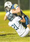  ?? DOUGLAS KILPATRICK / SPECIAL TOTHE MORNING CALL ?? Notre Dame wide receiver Zach Rogers gets brought down by Salisbury’s Gio Hines, 21, and Chad Parton during their first Colonial League Conference game at Notre Dame High School on Friday night.