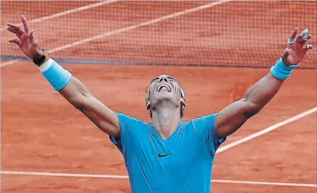  ?? MICHEL EULER THE ASSOCIATED PRESS ?? Spain’s Rafael Nadal celebrates winning the men’s final match of the French Open tennis tournament against Austria’s Dominic Thiem in three sets, 6-4, 6-3, 6-2, at the Roland Garros Stadium in Paris on Sunday. It was his 11th French Open title.